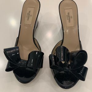 Black patent Valentino bow wedge heel slides